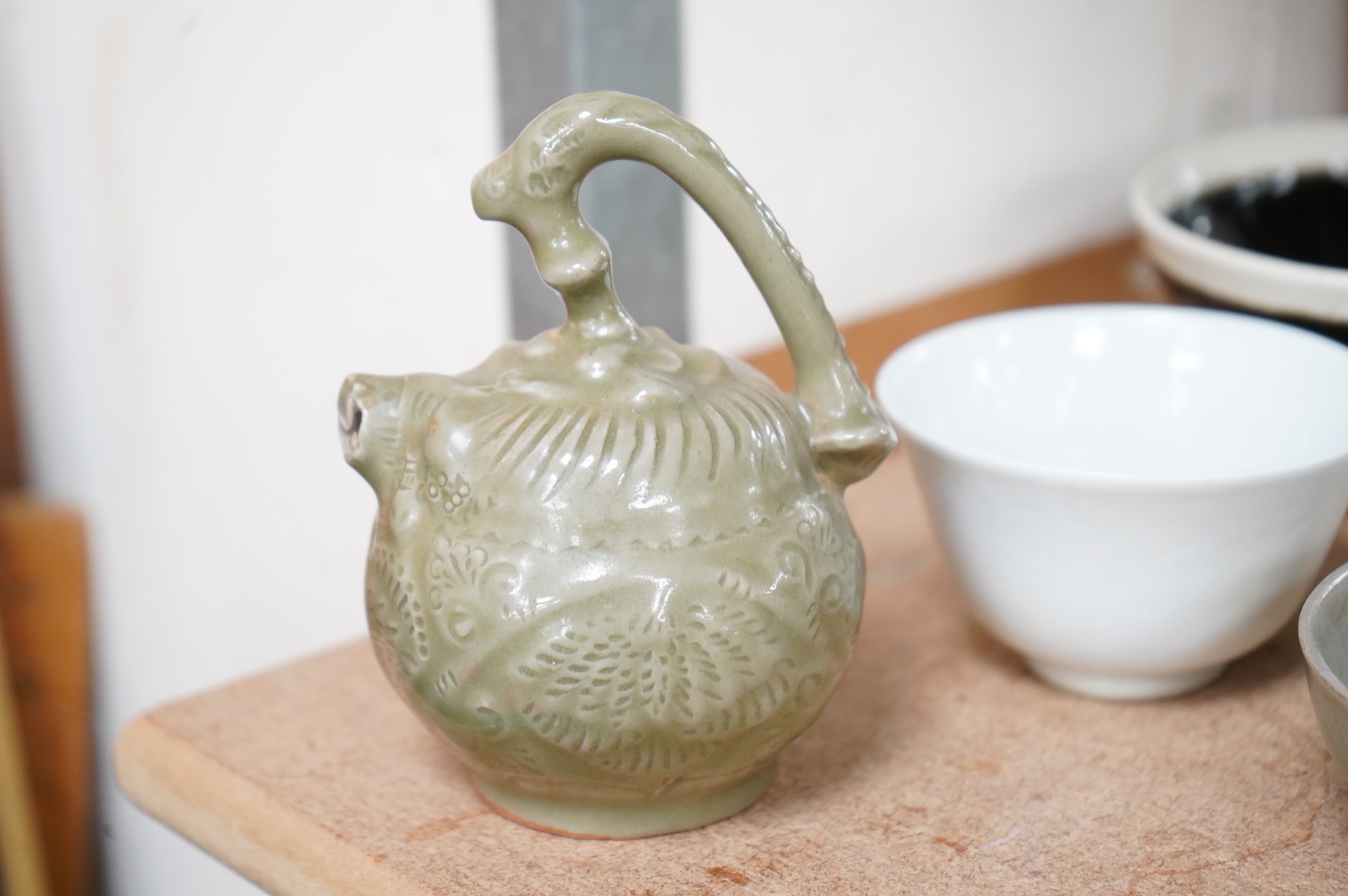 A collection of Chinese porcelain and pottery to include a naturalistic teapot, crackle glaze bowl and a ‘dragon’ bowl, largest 10cm in diameter